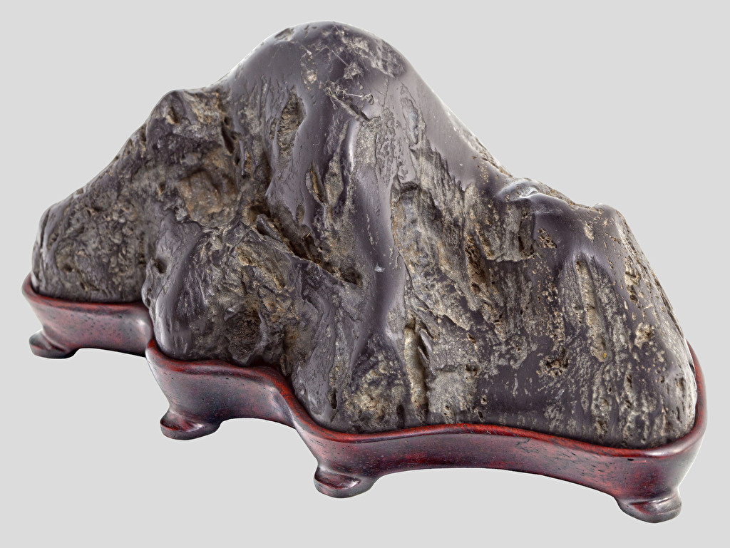 Suiseki” – “Kamogawaishi” type stone on a wooden mahogany base